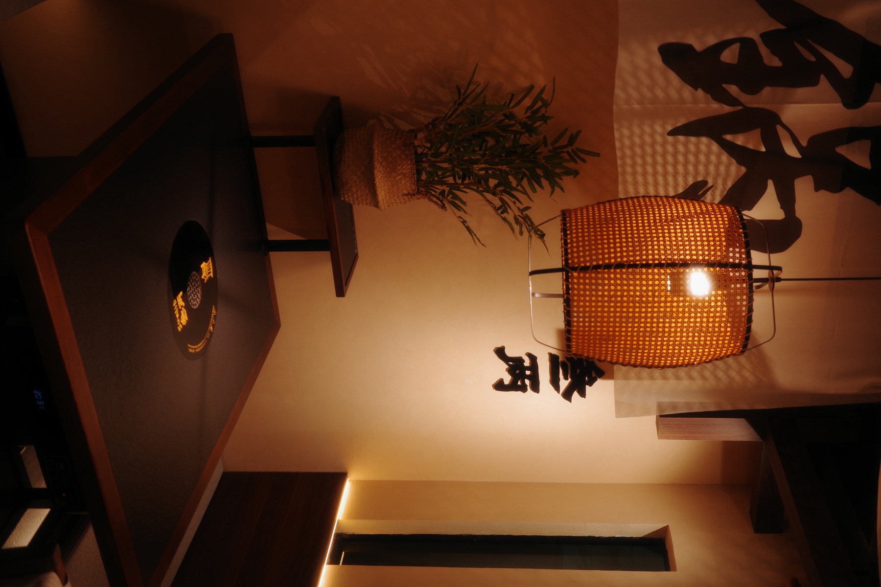 Private SUNLIT HOTPOT table corner with warm woven lantern lighting